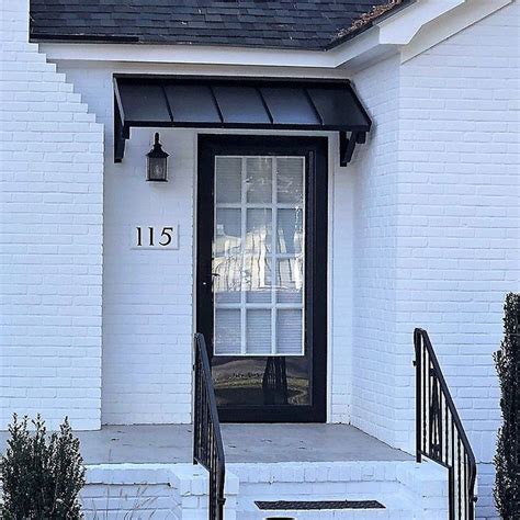 black metal awnings on a cream color house|Home.